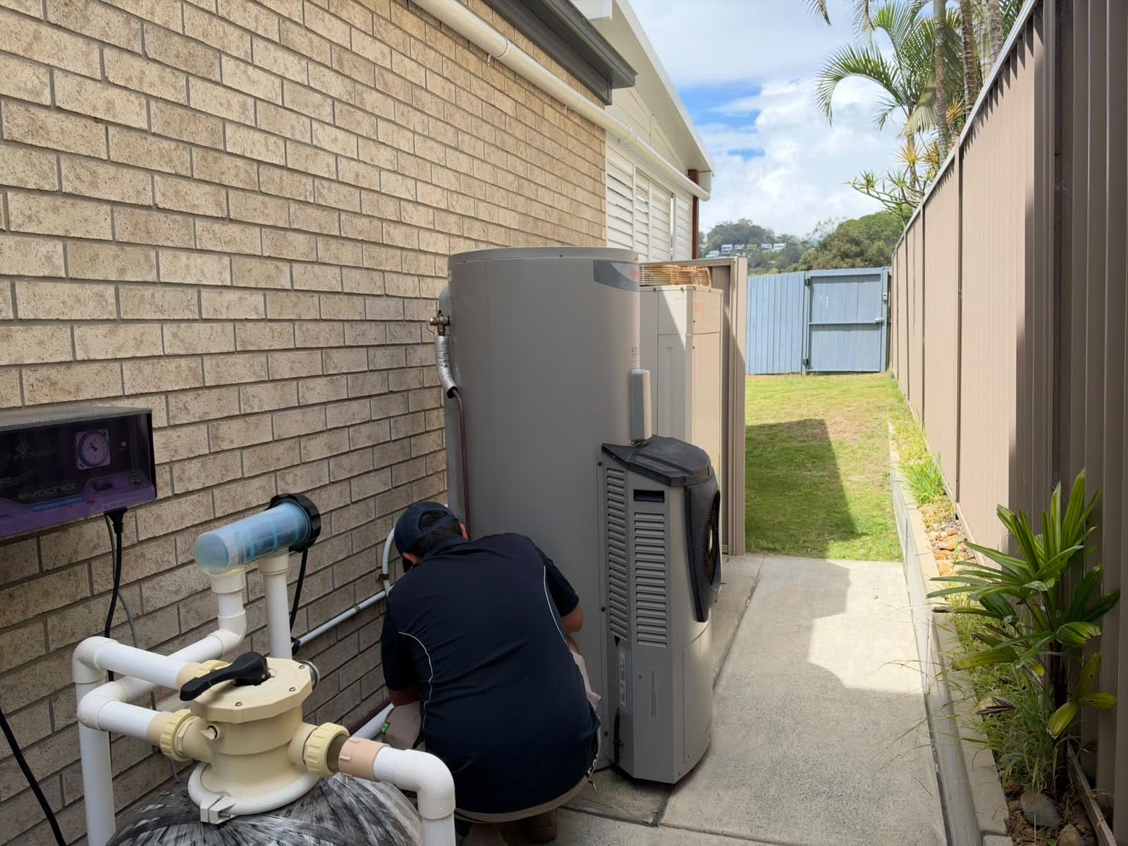Plumber working on a heat pump hot water system