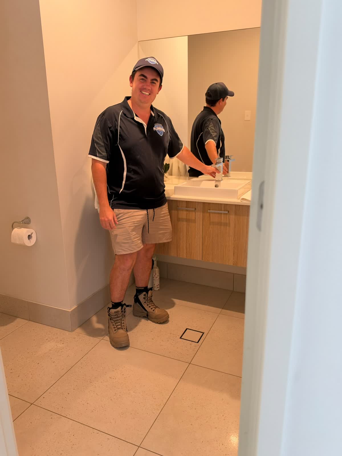 Gold Coast Plumbing plumber at a bathroom vanity